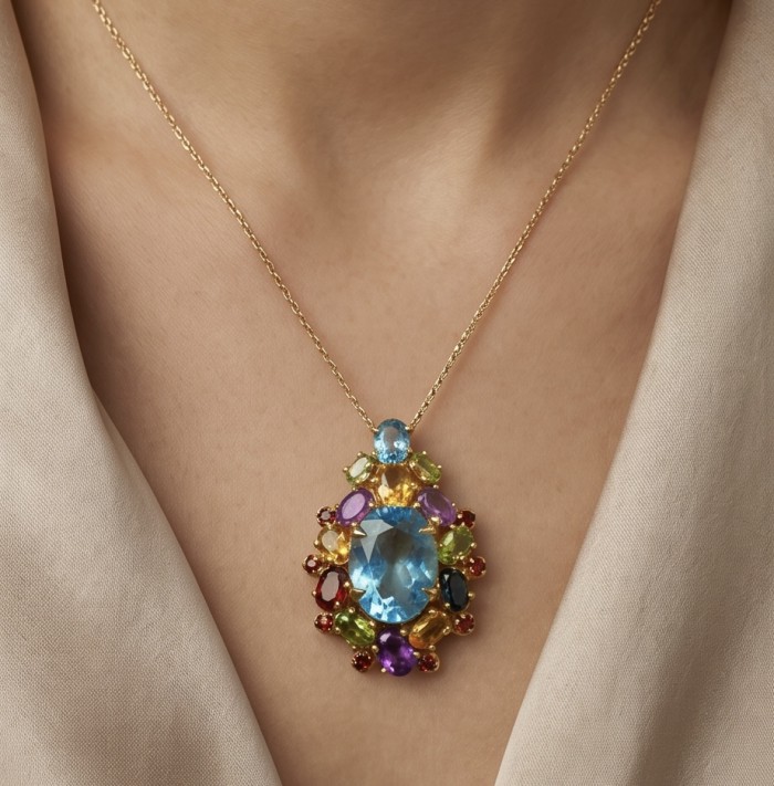 Majestic - Vintage style oval cut 15.8 carat Swiss Blue Topaz .925 Sterling Silver DIPPED IN 22 carat Gold handmade Pendant Brooch - Necklace with colorful gemstones worn on model's neck