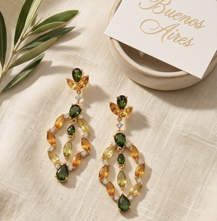 Romantica Authentic 10.5 carat Brazilain Citrine .925 Sterling Silver dipped in 18K Gold brilliantly handcrafted earrings - Top view of green and orange citrine earrings on a linen surface.