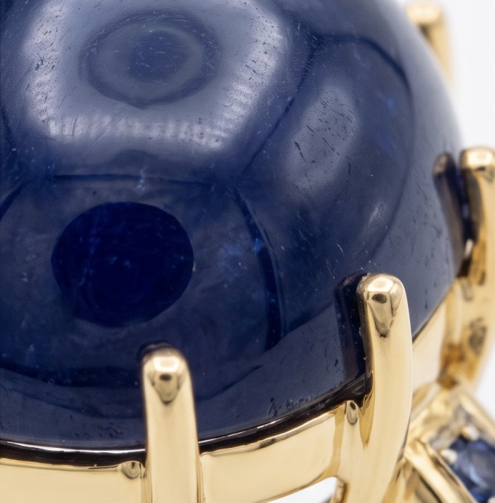 Blue Angel Genuine 34.5 carat Star Sapphire from Madagascar .925 Sterling Silver dipped in 18k Gold handcrafted Ring size 7 - Close-up of a 34.5 carat blue sapphire set in gold prongs.