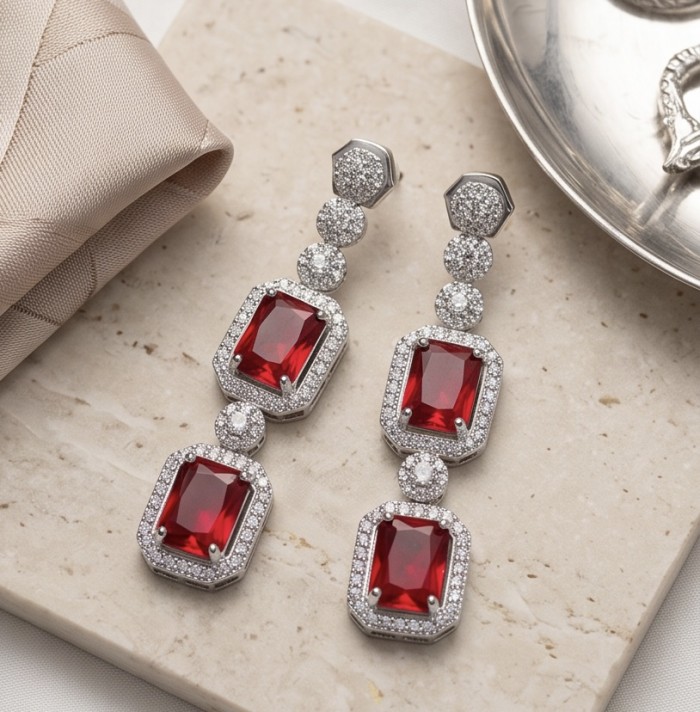 Exquisite 9.4 ctw Mozambique Ruby .925 Sterling Silver handcrafted Statement earrings - Elegant ruby earrings with diamond accents on a marble surface.