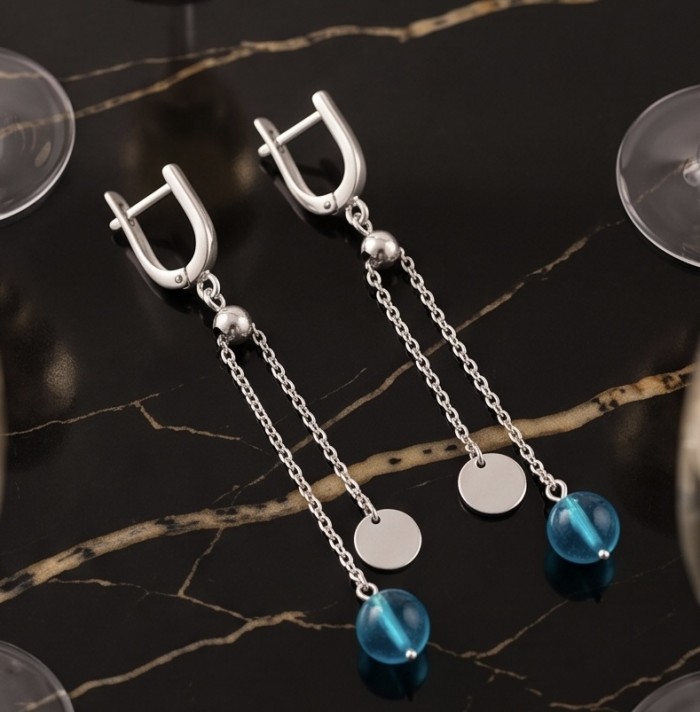 Dream 3.8 carat Apatite .925 Sterling Silver Handcrafted Statement earrings - Sterling silver earrings with blue apatite, top view on black marble.