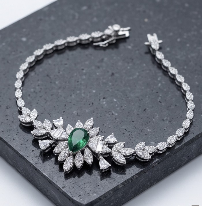 Giovanna - Authentic 4.5 carat Colombian Emerlad .925 Sterling Silver handcrafted Statement bracelet - Bracelet with emerald and diamond detail on a dark surface angle view