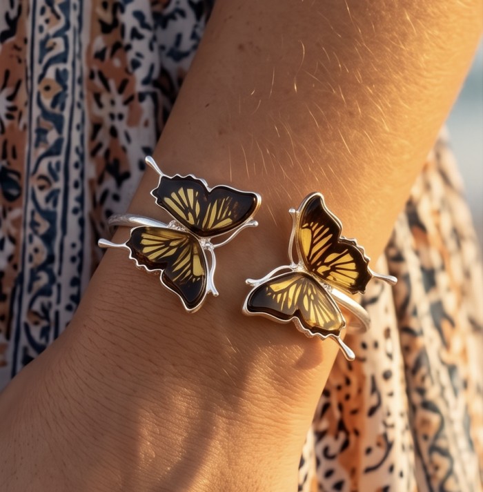 Golden Butterfly Genuine carved Baltic Amber .925 Sterling Silver dipped in rhodium handamde Bracelet - Golden butterfly bracelets worn on wrist, close-up shot.