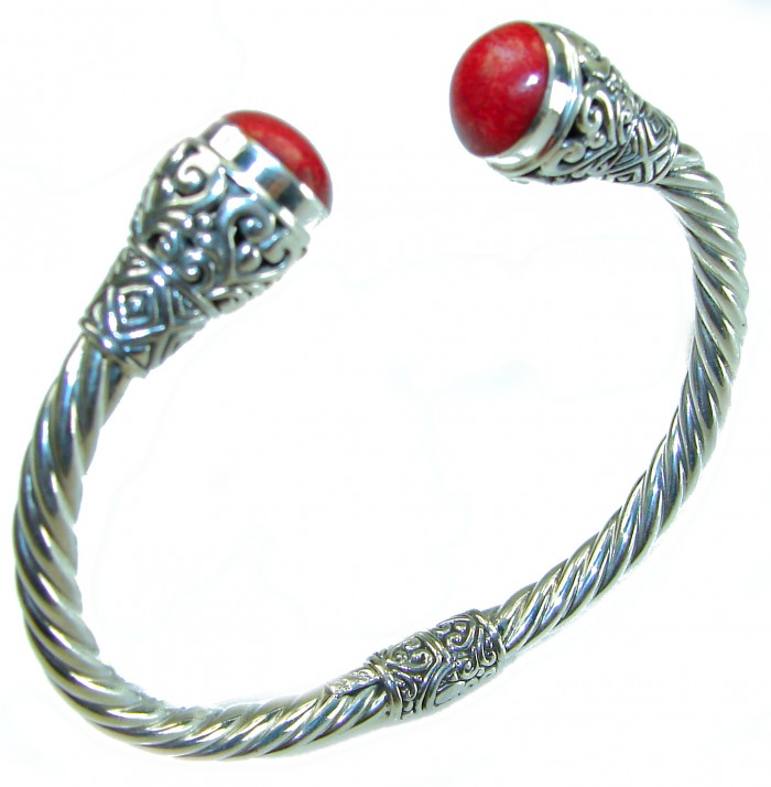 10.5 carat Fossilized Coral .925 Sterling Silver handcrafted Statement Bali made Bracelet - Top view of twisted sterling silver bracelet with red fossilized coral ends.