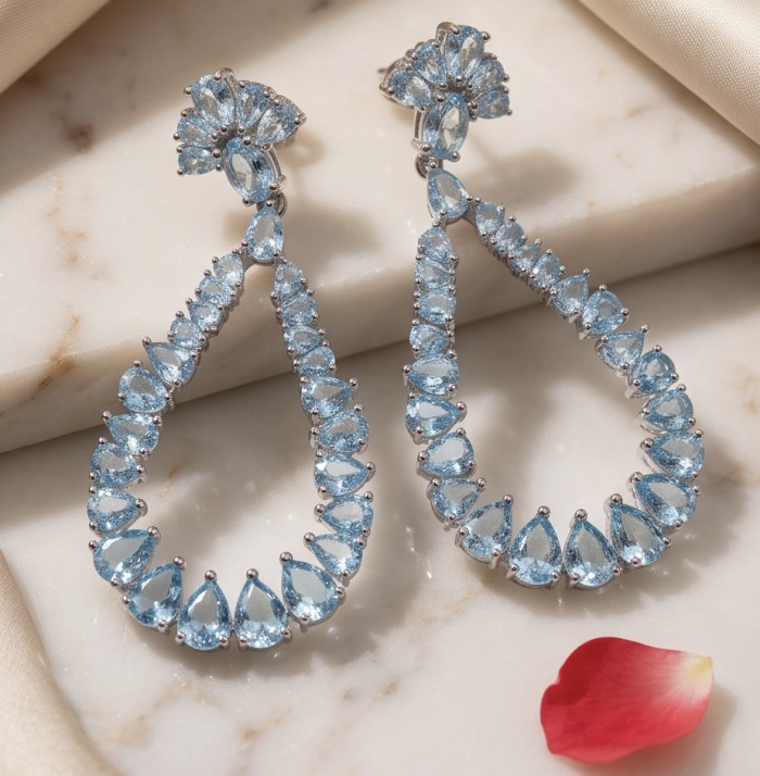 Serenity 14.5 carat genuine Swiss Blue Topaz .925 Sterling Silver handmade Statement Handcrafted earrings - Swiss Blue Topaz earrings on marble surface with a close-up view