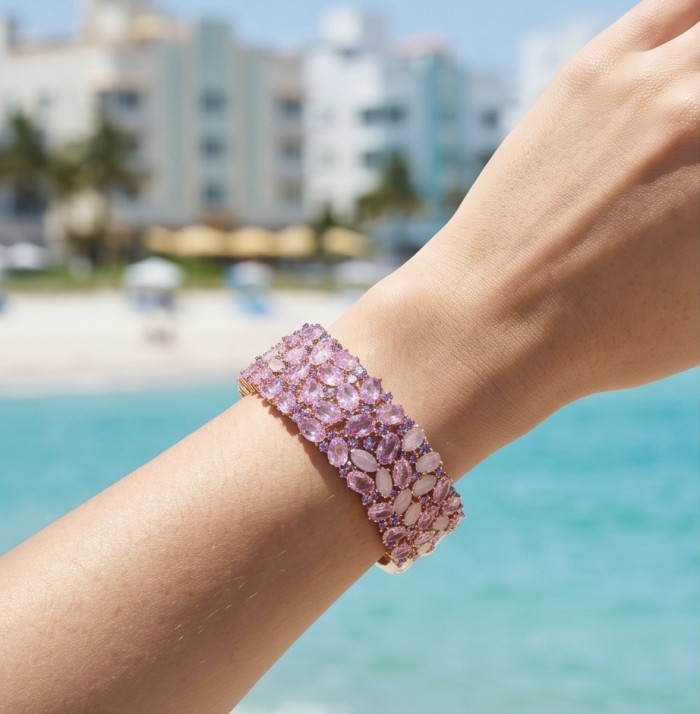 Luxurious 45.4 carat Pink Sapphire 1.8 carat Tanzanite 8.2 carat Rose Quartz 22K real ROSE Gold over .925 Sterling Silver handcrafted Bracelet - Pink sapphire bracelet worn on wrist with beach background.