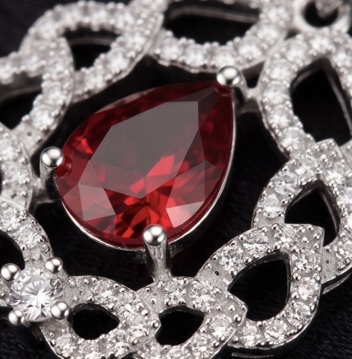 3.8 carat authentic Mozambique Ruby rhodium over .925 Sterling Silver handmade Pendant - Close-up of Mozambique ruby pendant with surrounding diamonds.