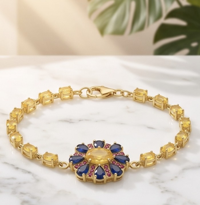 Luxurious 12.5 carat oval cut Yellow Sapphire 18K Gold over .925 Sterling Silver handcrafted Statement Bracelet - Yellow sapphire bracelet, top view, yellow and blue stones, on marble surface.