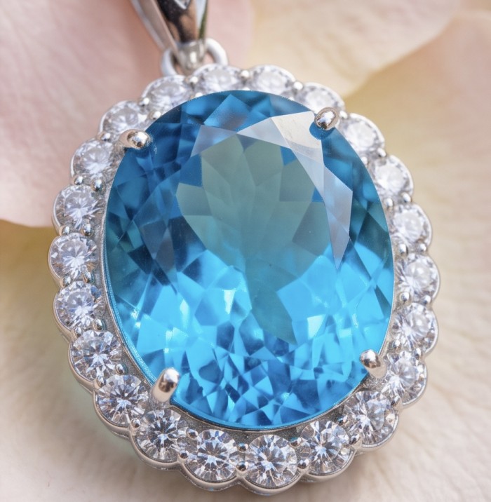 Tiffany Incredible oval cut 45.4 carat Swiss Blue Topaz rhodium over .925 Sterling Silver handcrafted pendant - Close-up of oval cut Swiss Blue Topaz pendant with diamond halo.