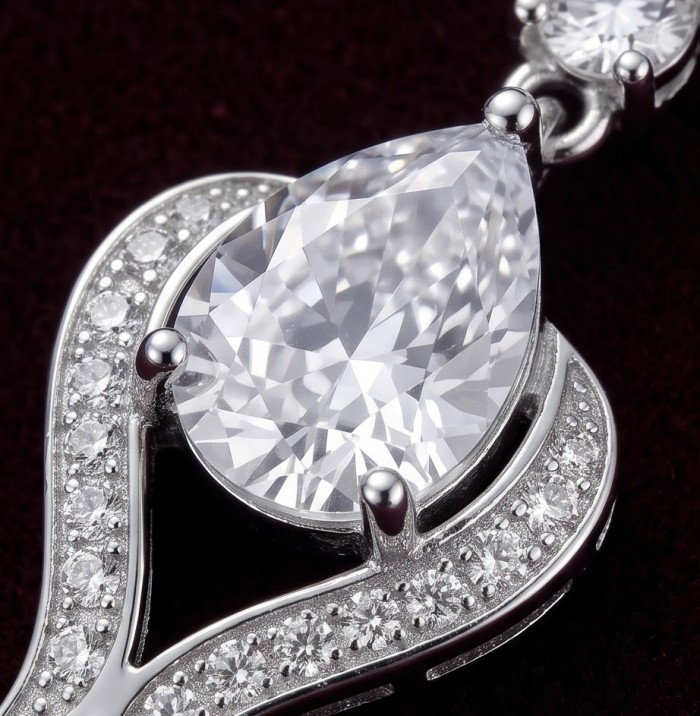Top quality Sublime 3.8 carat White Topaz rhodium over .925 Sterling Silver handcrafted Earrings - Close-up of pear-shaped white topaz pendant with rhodium details.