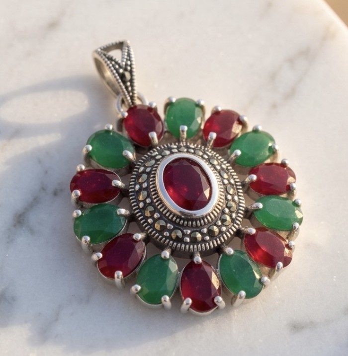 Giovanna 22.2 carat authentic Ruby Emerald Marcasite .925 Sterling Silver handmade Pendant - Ruby and emerald pendant laid flat on marble surface.
