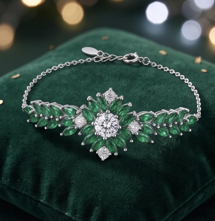 Giovanna - Authentic 10.9 carat COLOMBIAN EMERALD .925 Sterling Silver handcrafted bracelet - Emerald bracelet displayed on green cushion, front view.