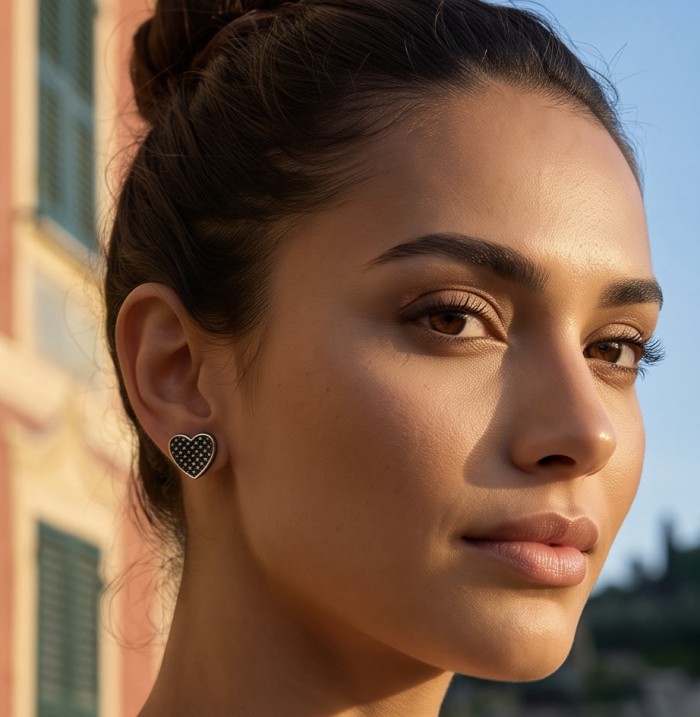 Simple Elegance Black Spinel .925 Sterling Silver dipped in black rhodium earrings - Side view of woman wearing Black Spinel heart earrings in sunlight.
