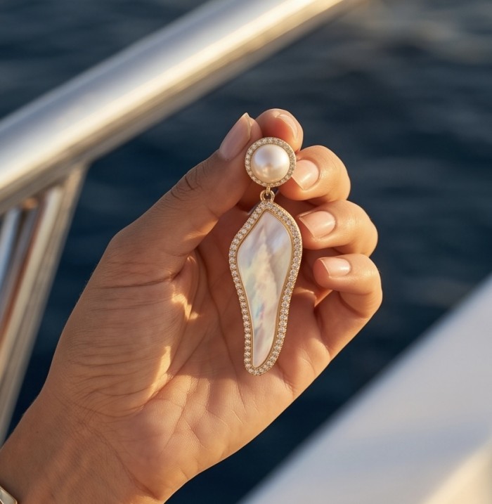Luxurious Genuine Blister Pearl 0.4 CARAT lab grown Diamond 18K Gold over .925 Sterling Silver handcrafted Statement Earrings - Earring with blister pearl and diamonds held in hand, ocean background