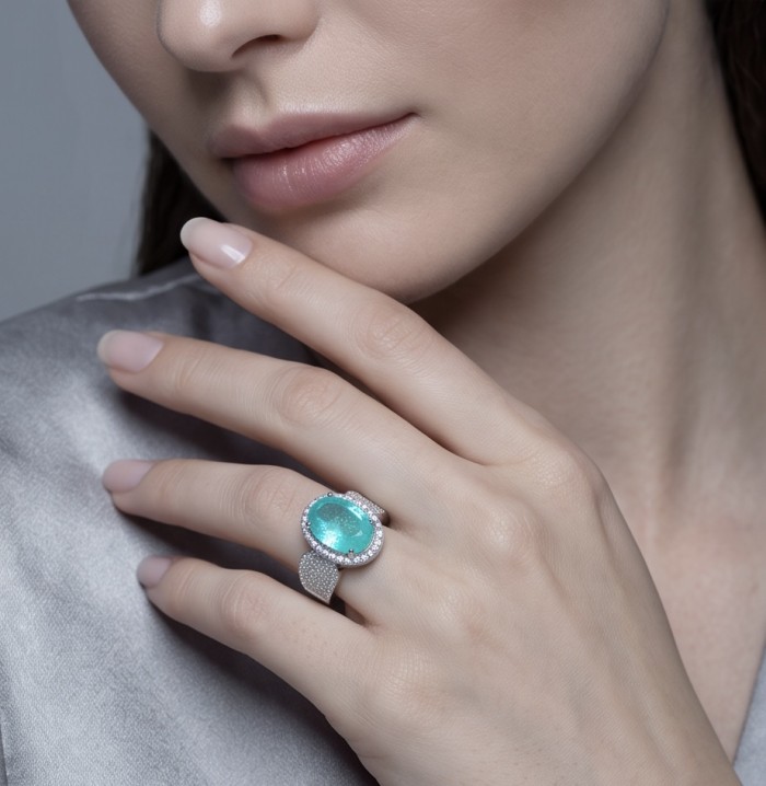 Elizabeth oval cut 14.8 carat Colombian Emerald .925 Sterling Silver dipped in Rhodium handcrafted Ring size 8 - Close-up of Colombian Emerald ring worn on hand, showing detail.