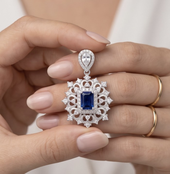 Born to Glam 2.2 carat natural Sapphire .925 Sterling Silver Perfectly handcrafted Pendant - Close-up of Sapphire pendant held between fingers, detailed design shown