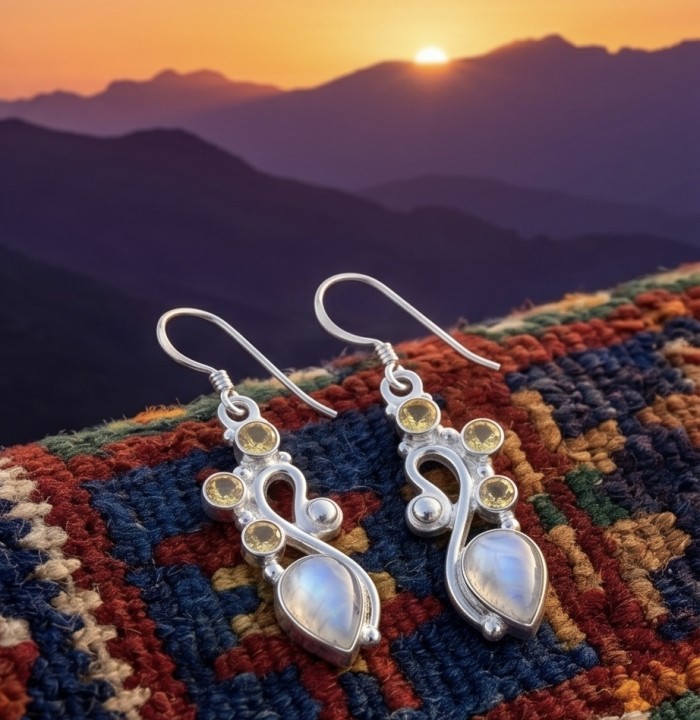 Cascades OF LIGHT Genuine 7.2 carat Fire Moonstone .925 Silver handcrafted earrings - Earrings on colorful fabric with sunset; focus on design and stones.