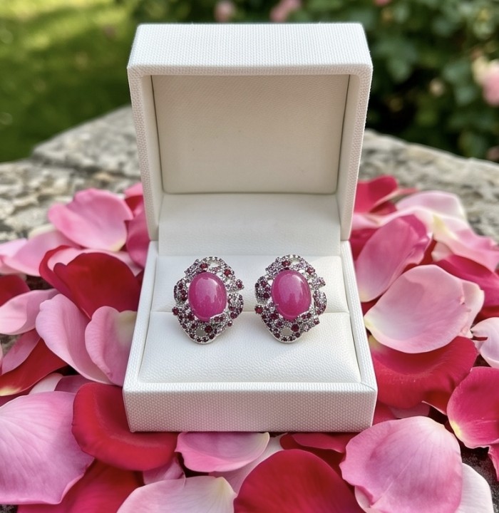 Francesca- Magnificent 10.8 carat authentic Ruby rhodium over .925 Sterling Silver handcrafted Statement earrings - Ruby earrings in box on rose petals, front view.