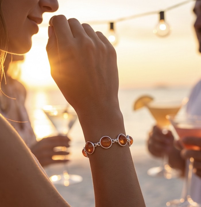 Excellent quality Cognac color Baltic Amber .925 Sterling Silver entirely handcrafted Bracelet - Cognac Baltic Amber bracelet on wrist at sunset party.