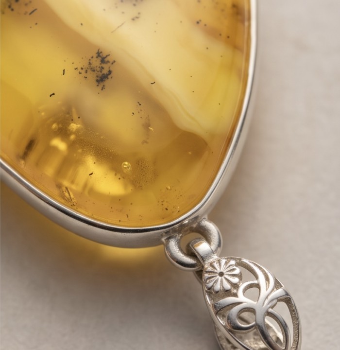 Prehistoric Authentic Golden Butterscotch Baltic Amber .925 Sterling Silver beautifully handcrafted Pendant - Stone close-up of golden butterscotch Baltic amber pendant with silver detail