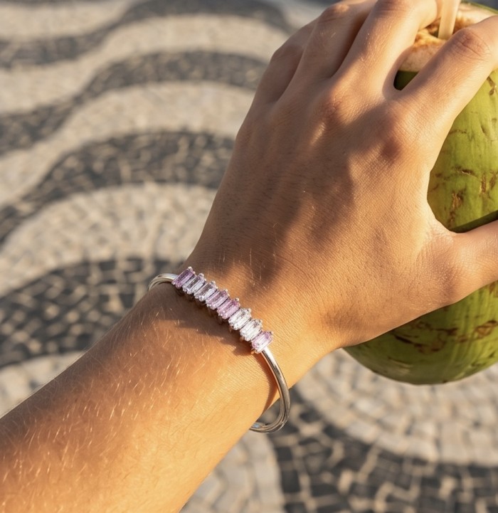 Precious Light Natural 6.8 carat Pink Topaz .925 Sterling Silver bracelet - Worn on hand: Pink Topaz bracelet in sunlight, holding a coconut.