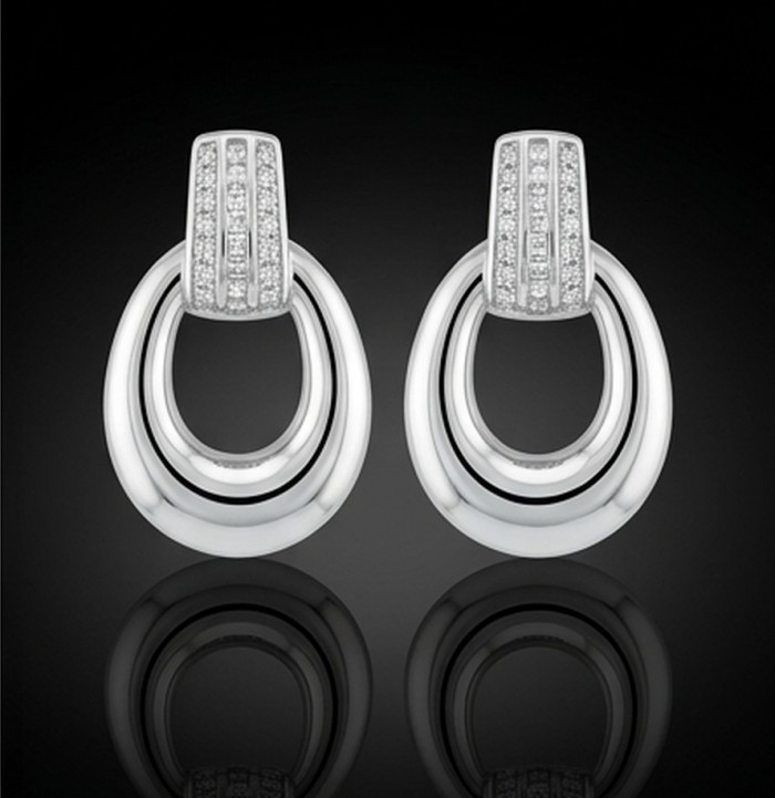 Genuine 0.9 carat White Topaz .925 Sterling Silver handcrafted Statement Earrings - Sterling silver and white topaz earrings, front view with black background.