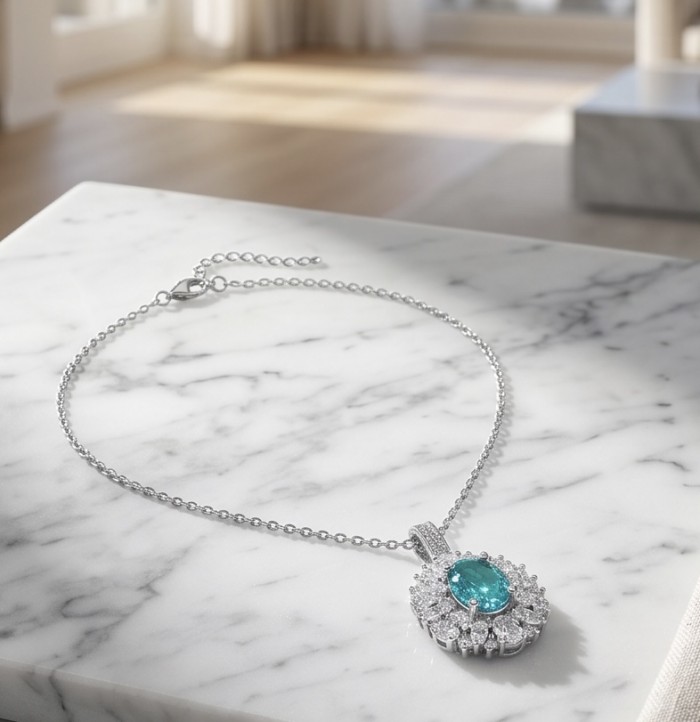 Wonderland 6.8 carat Paraiba Tourmaline .925 Sterling Silver Handcrafted Statement necklace - Pendant necklace on marble surface, showcasing Paraiba Tourmaline centerpiece.