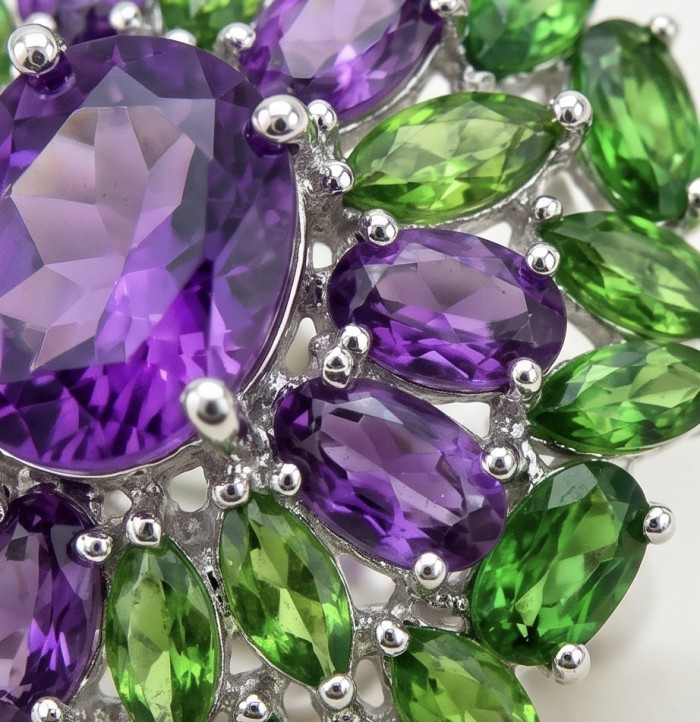 Rosaria Genuine 12.7 carat Brazilian Amethyst rhodium over .925 Sterling Silver handcrafted Statement Ring size 7 3/4 - Close-up of Rosaria Amethyst and green gemstone jewelry.