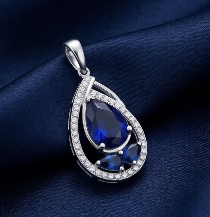 Vintage Beauty 5.7 carat Sapphire Rhodium over .925 Sterling Silver handcrafted pendant - Close-up of Vintage Beauty sapphire pendant on dark fabric background.