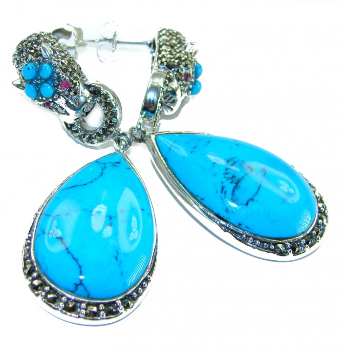 Great authentic Sleeping Beauty Turquoise .925 Sterling Silver handcrafted STATEMENT Earrings - Close-up of turquoise teardrop earrings with silver detailing.
