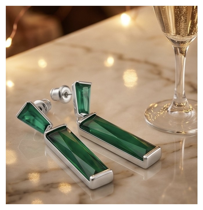 Amazing authentic 8.2 carat Green Helenite .925 Sterling Silver earrings - Top view of green Helenite earrings on marble with champagne flute.