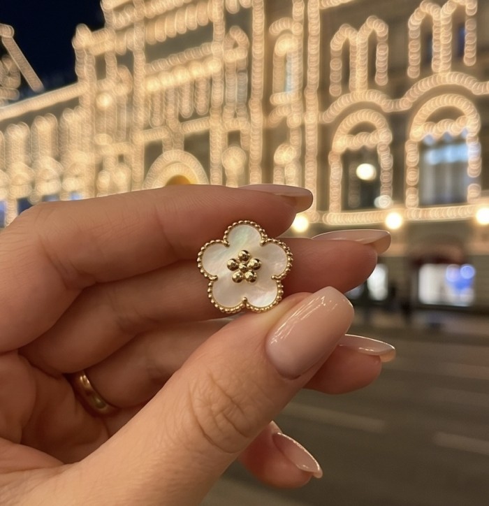 Genuine Blister Pearl .925 Sterling Silver handcrafted Statement Earrings - Close-up of flower-shaped pearl jewelry held in hand, background lights.