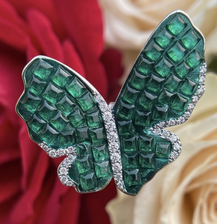 Incredible Butterflies genuine mystery setting 15.5 CARAT Emerald .925 Sterling Silver handcrafted Earrings - Close-up of butterfly jewelry with emerald and diamond details.