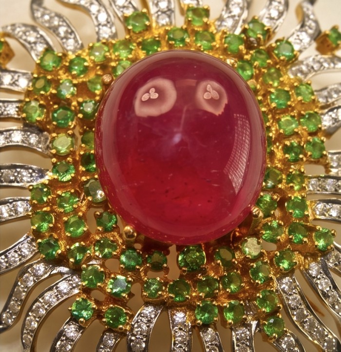 Abundant Blessings - Precious - Genuine 27.5 carat Ruby 18K Gold over .925 Sterling Silver handmade Pendant and Brooch - Close-up of 27.5 carat ruby surrounded by green stones and diamonds.