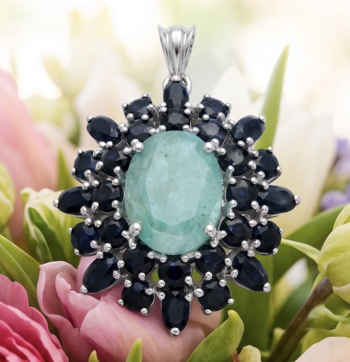 Buena Vista - authentic 21.5 carat Colombian Emerald Sapphire rhodium over .925 Sterling Silver handcrafted Pendant - Close-up of Buena Vista emerald and sapphire pendant against flowers.