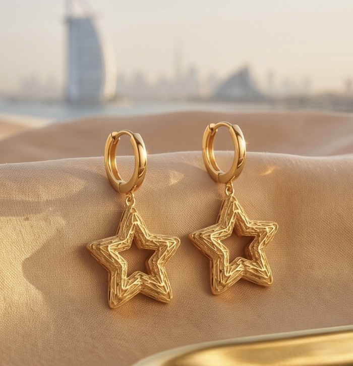 Golden Stars - Dubai Style - .925 Sterling Silver dipped in 22K Gold handmade Earrings - Gold star earrings in front of Dubai skyline, side view