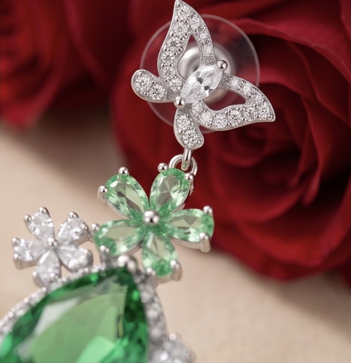 Green Cascade - 18.5 carat Green Topaz rhodium over .925 Sterling Silver handmade Statement earrings - Close-up of Green Cascade earrings with floral and butterfly detail.