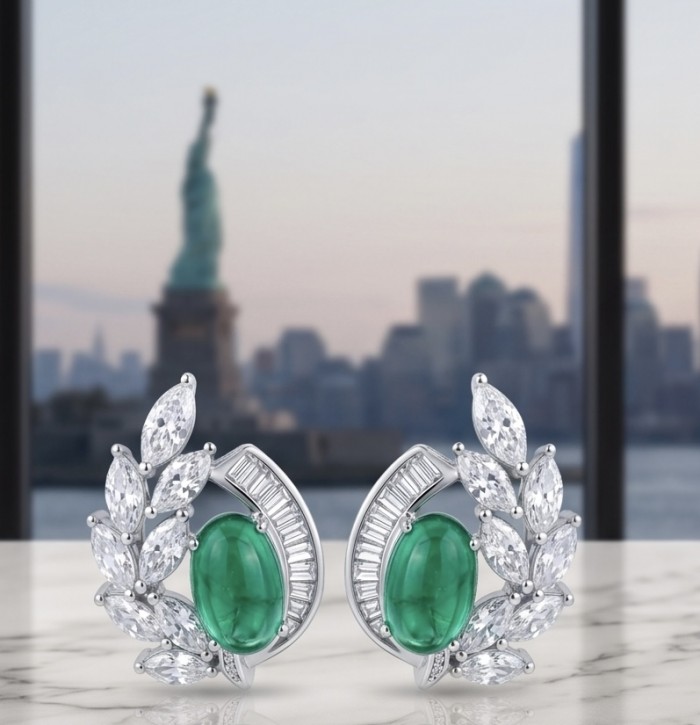 Luxurious - 7.2 carat Colombian Emerald .925 Sterling Silver dipped in rhodium handmade Statement Earrings - Emerald and diamond earrings with cityscape background, front view.