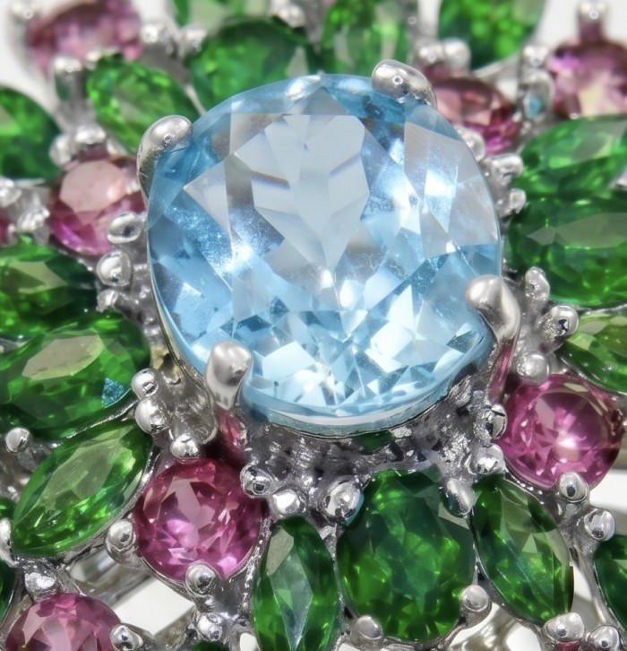 Exquisite 19.7 carat Swiss Blue Topaz rhodium over .925 Sterling Silver Handcrafted Statement Ring size 9 - Stone close-up of Swiss Blue Topaz with green and pink accents.