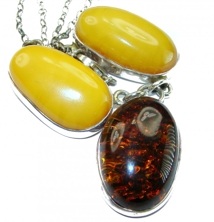 Wonderful 2 Colors Elegant Genuine Baltic Amber .925 Silver handcrafted Necklace - Close-up of two-color Baltic amber pendants in silver settings.