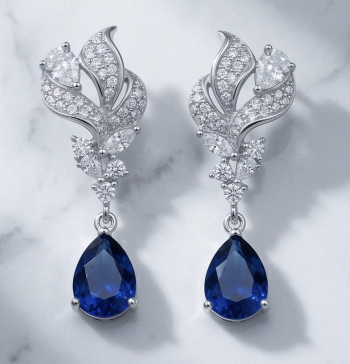 Blue Royalty 3.7 carat Sapphire .925 Sterling Silver handcrafted Statement earrings - Elegant sapphire earrings with diamonds on a marble surface, front view