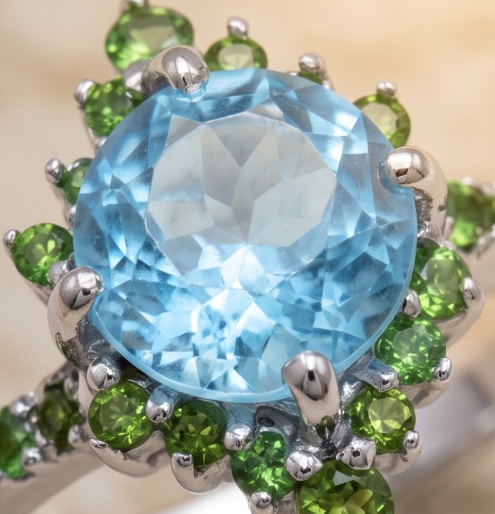 Pacifica 4.8 carat Swiss Blue Topaz .925 Sterling Silver handcrafted ring size 9 - Close-up of Pacifica Swiss Blue Topaz with green stones in silver setting