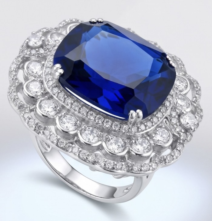 Precious Design oval cut 22.9 CARAT Tanzanite rhodium over .925 Sterling Silver Statement Ring s. 6 3/4 - Close-up of an ornate ring with a large blue tanzanite centerpiece.