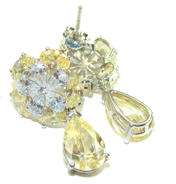 Luxurious 10.5 carat Golden - yellow Montana Sapphire .925 Sterling Silver handcrafted earrings - Close-up of luxurious golden-yellow sapphire earrings with flower design.