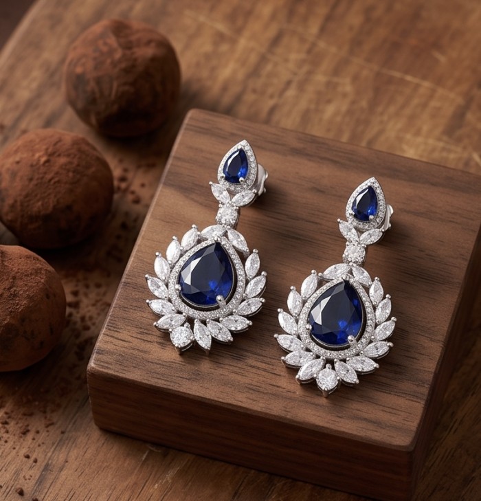 Vintage style - Giovanna - Authentic pear cut 8.9 carat Sapphire .925 Sterling Silver handcrafted earrings - Vintage-style earrings with pear-cut sapphire and diamonds on wood display.