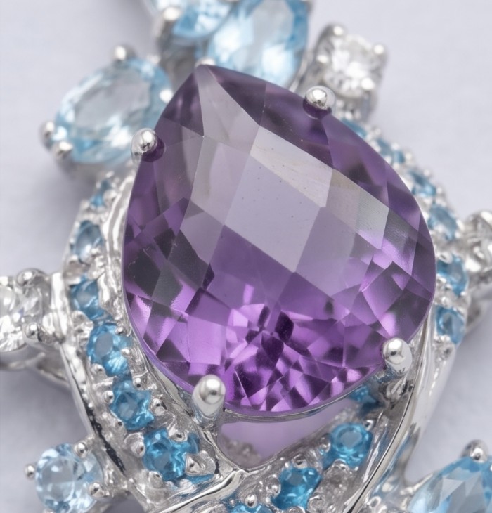 RARE BEAUTY! Valentina 22.2 carat Amethyst .925 Sterling Silver dipped in rhodium Statement pendant - Close-up of amethyst and blue stones on sterling silver jewelry.