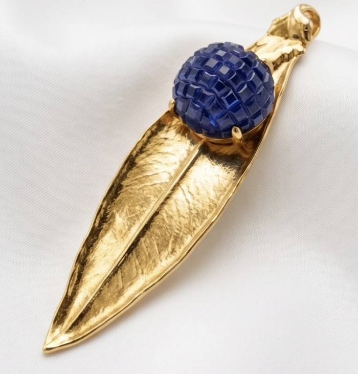 Stylish REAL Leaf dipped in Real gold mystery setting 5.2 carat Sapphire .925 Sterling Silver Pendant - Gold leaf pendant with blue stone, top view on white fabric