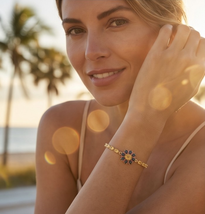 Luxurious 12.5 carat oval cut Yellow Sapphire 18K Gold over .925 Sterling Silver handcrafted Statement Bracelet - Woman wearing yellow sapphire bracelet on wrist in sunny outdoor setting
