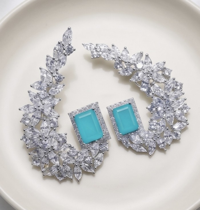 Royalty 4.2 carat Paraiba Tourmaline .925 Sterling Silver entirely handmade earrings - Earrings with Paraiba tourmaline and crystals on a white plate.