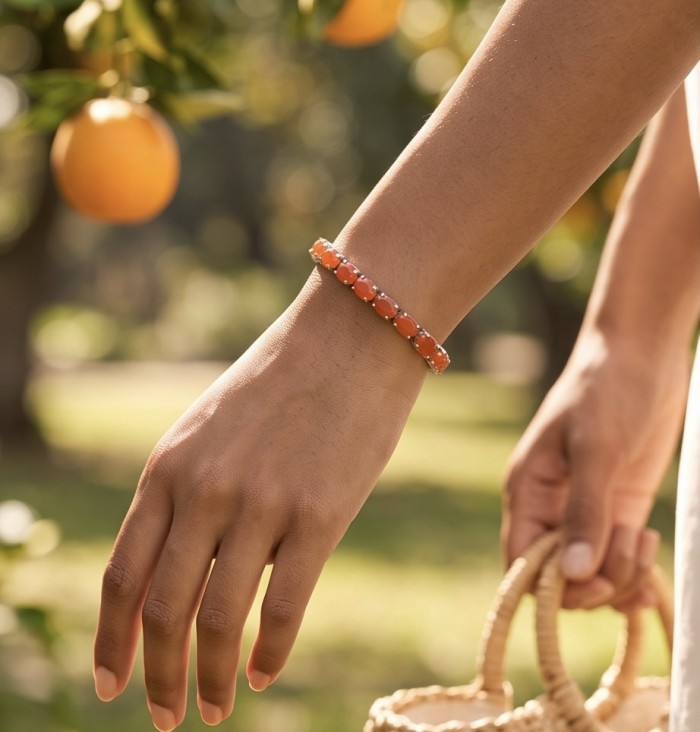 Sublime Brilliance 26.8 carat Authentic Orange Fire Opal .925 Sterling Silver handcrafted bracelet - Bracelet worn on hand, orange stones in outdoor setting with oranges.